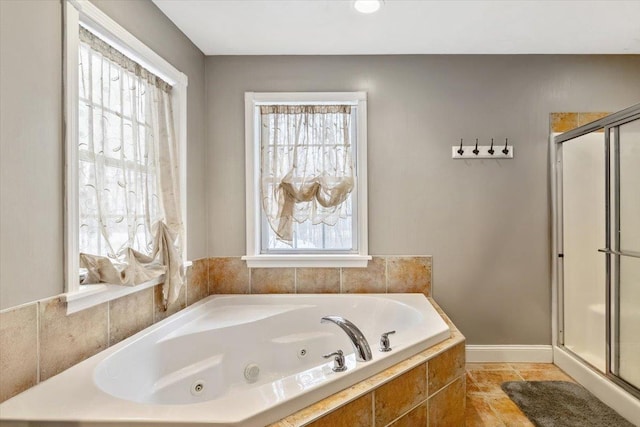 full bath featuring baseboards, a tub with jets, a stall shower, and tile patterned floors