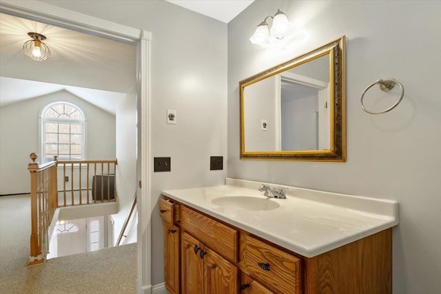 bathroom featuring vaulted ceiling and vanity