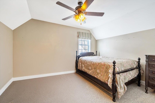 bedroom with baseboards, vaulted ceiling, and light colored carpet