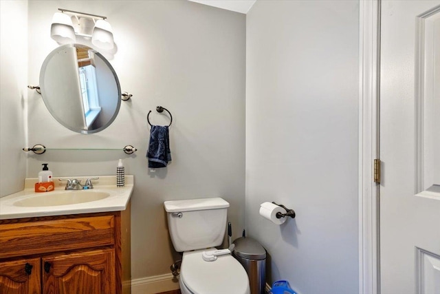 bathroom featuring toilet and vanity