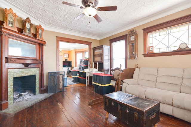 living area featuring a fireplace with flush hearth, ornamental molding, dark wood finished floors, and an ornate ceiling