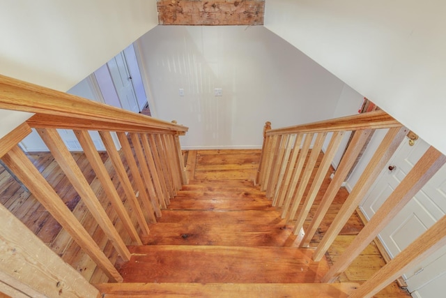 stairway with wood finished floors