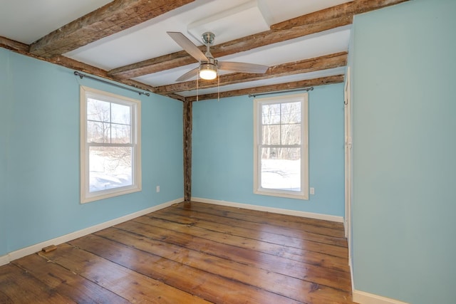 spare room featuring ceiling fan, beam ceiling, baseboards, and wood finished floors