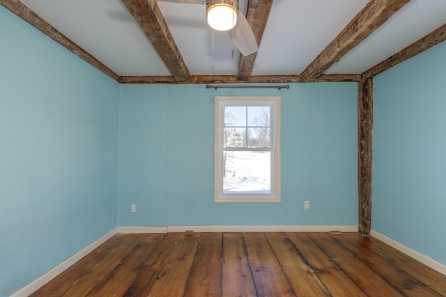 spare room featuring beam ceiling, baseboards, and dark wood-style flooring