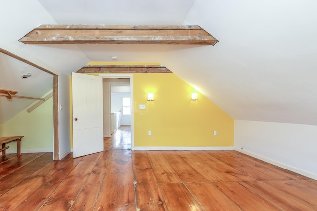 bonus room featuring vaulted ceiling, wood finished floors, and baseboards