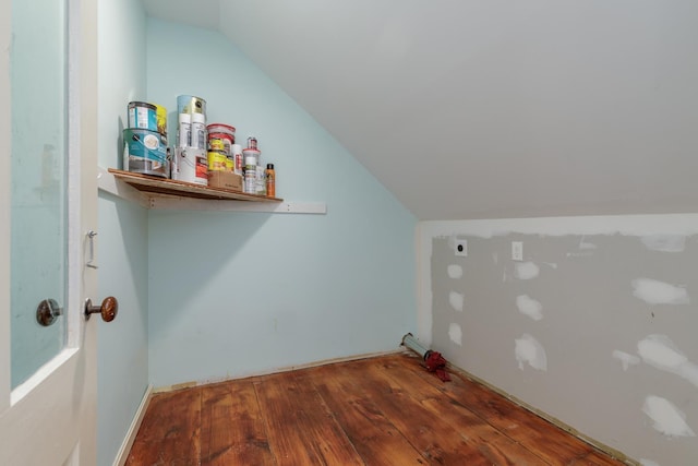 clothes washing area featuring electric dryer hookup and wood finished floors