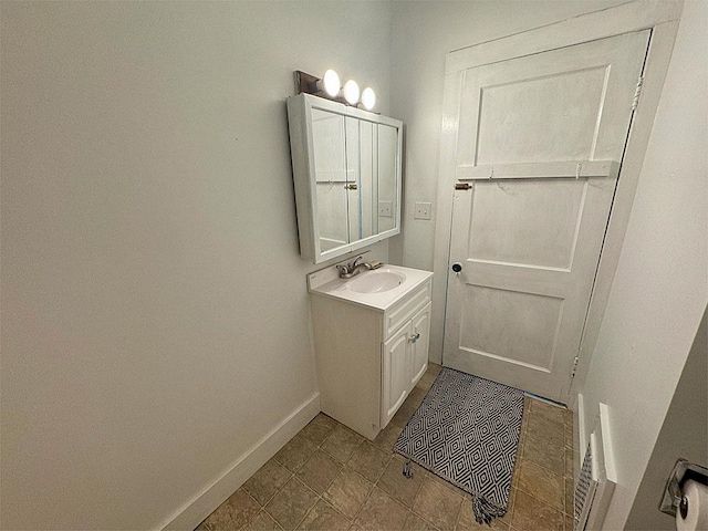 bathroom featuring baseboards and vanity