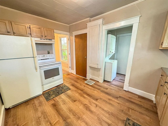 kitchen featuring stacked washer and dryer, white appliances, light brown cabinets, and ornamental molding