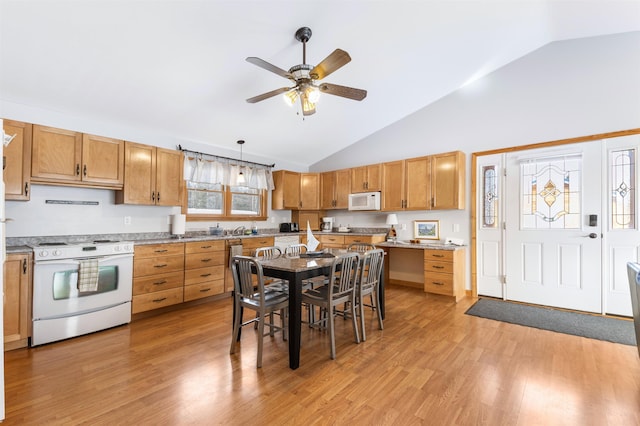 kitchen featuring white appliances, hanging light fixtures, light countertops, brown cabinets, and light wood finished floors