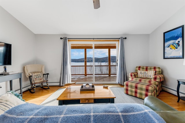 living area featuring light wood finished floors and a baseboard radiator