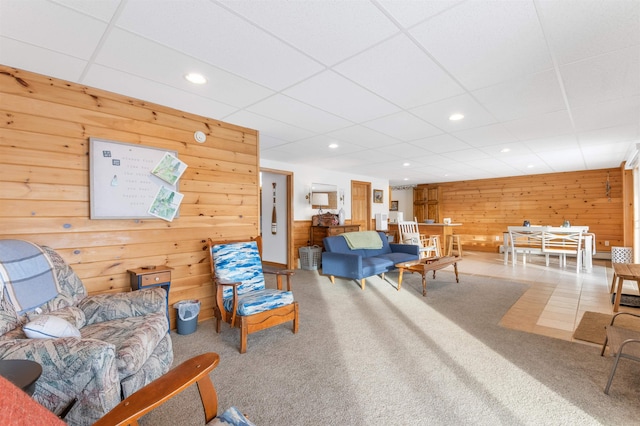 living room featuring wood walls, carpet flooring, and recessed lighting