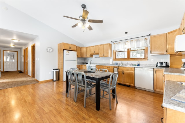 kitchen featuring hanging light fixtures, white appliances, light wood-type flooring, and light countertops