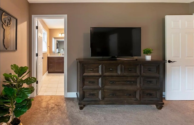 living room with light carpet, baseboards, and light tile patterned flooring