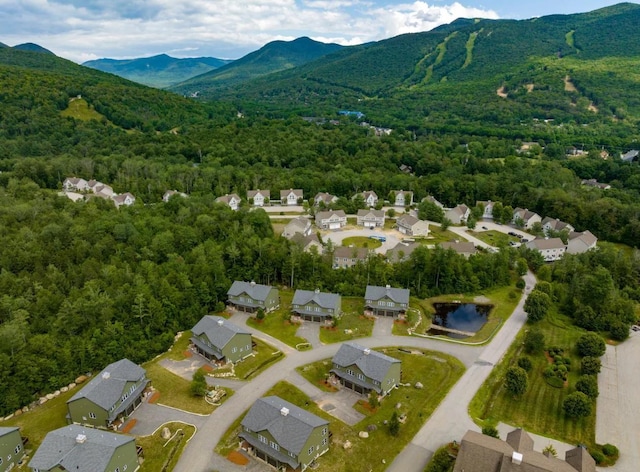 drone / aerial view featuring a residential view and a water and mountain view