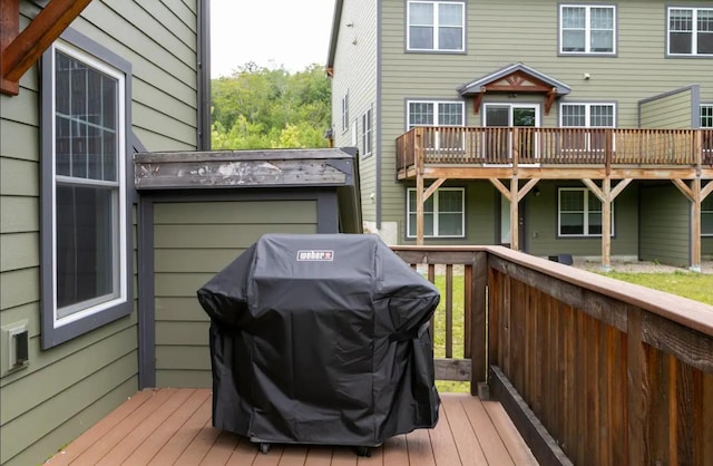 wooden terrace with a grill