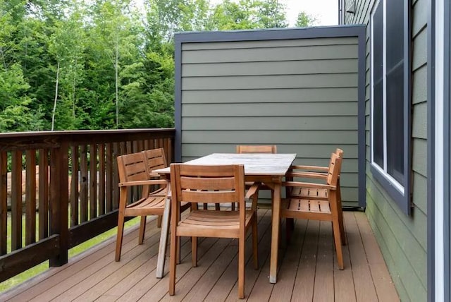 wooden terrace with outdoor dining area