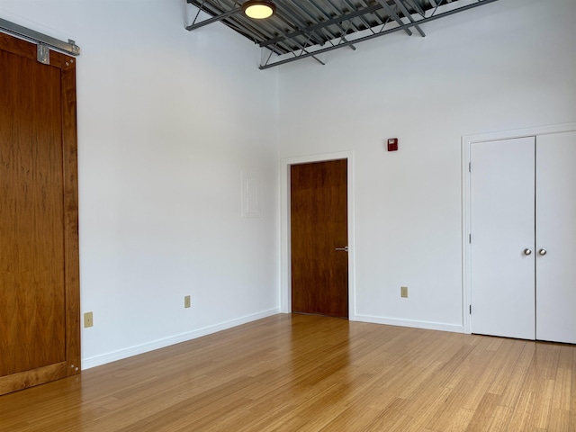 empty room featuring light wood-style flooring and baseboards