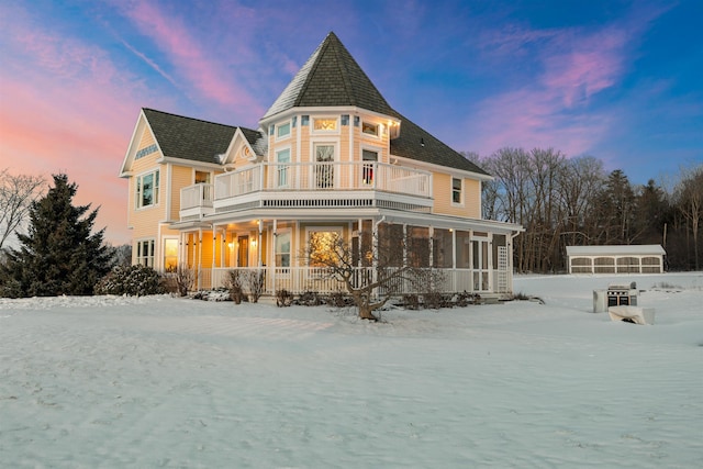 view of snow covered rear of property