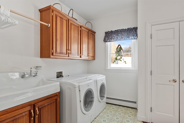 laundry room featuring washer and clothes dryer, a baseboard radiator, a sink, and cabinet space