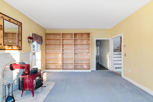 interior space with a wood stove and baseboards