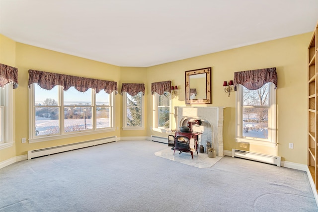 unfurnished room featuring a wood stove, baseboard heating, and light colored carpet