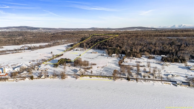 snowy aerial view featuring a mountain view