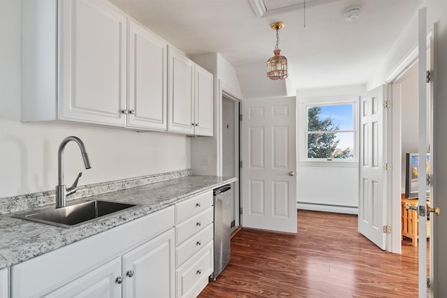 kitchen featuring white cabinets, dishwasher, hanging light fixtures, a baseboard heating unit, and a sink