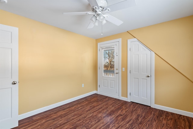 unfurnished bedroom with dark wood-style floors, ceiling fan, and baseboards