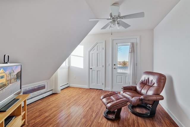 living area with a wealth of natural light, baseboards, and light wood finished floors