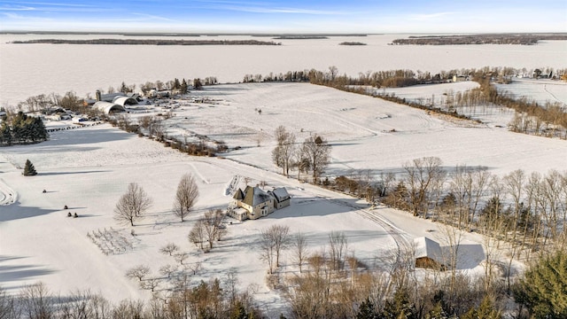 snowy aerial view with a water view