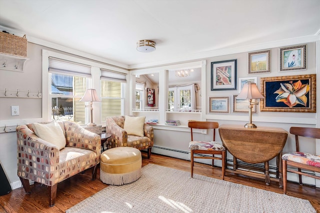 sitting room featuring crown molding and wood finished floors