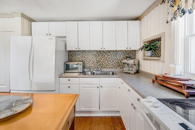 kitchen featuring a toaster, white appliances, light countertops, and white cabinetry