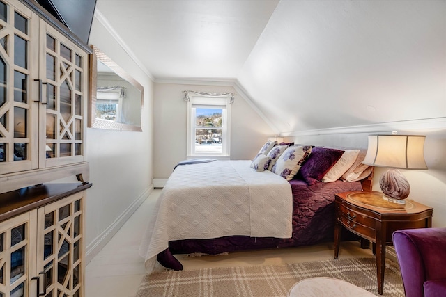 bedroom with vaulted ceiling, ornamental molding, and baseboards