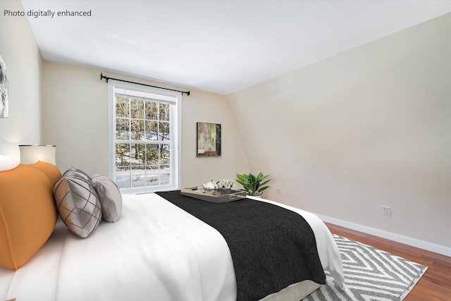 bedroom featuring baseboards and wood finished floors