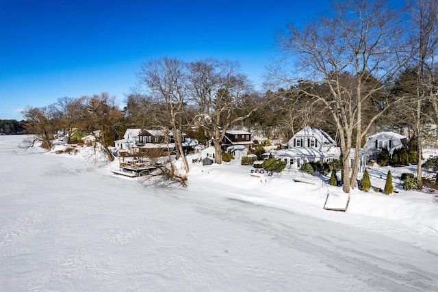 yard layered in snow with a residential view