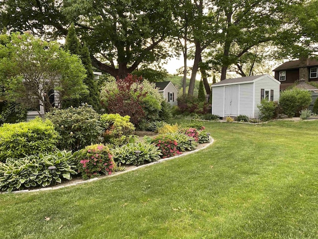 view of yard with an outbuilding and a shed