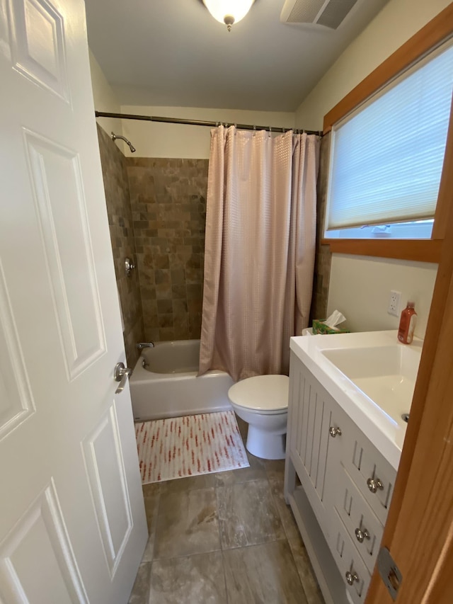 bathroom featuring visible vents, vanity, shower / bath combination with curtain, and toilet