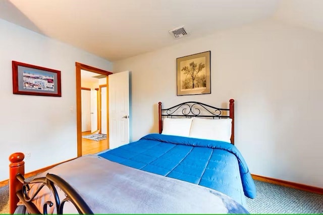 carpeted bedroom with visible vents and baseboards