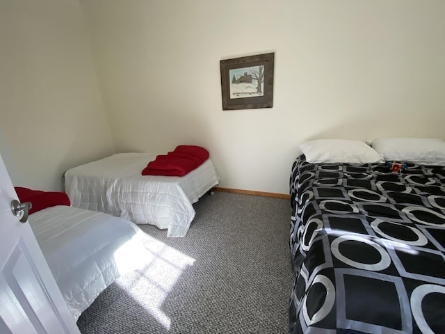 carpeted bedroom featuring baseboards