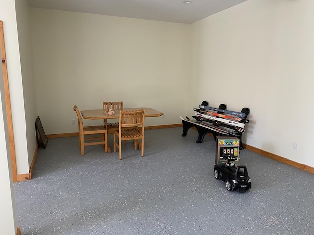 rec room featuring baseboards and speckled floor