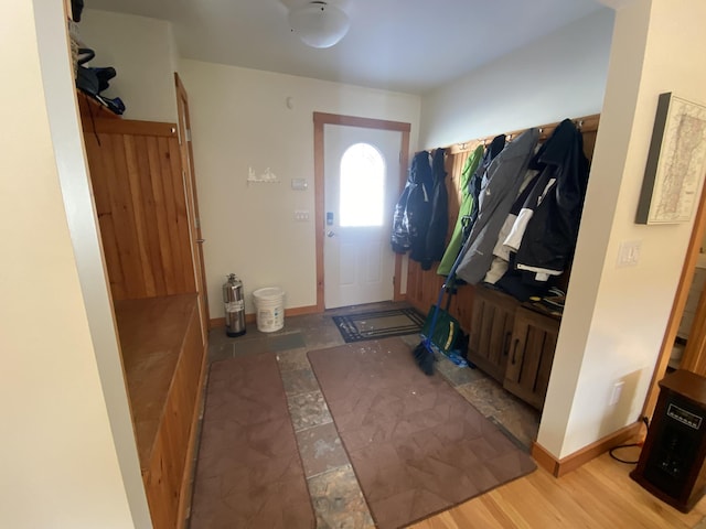 mudroom featuring baseboards and wood finished floors