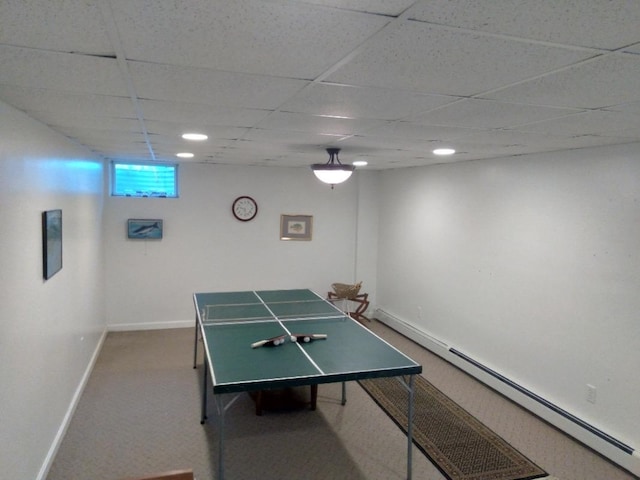 rec room featuring carpet floors, baseboards, a baseboard heating unit, and a drop ceiling