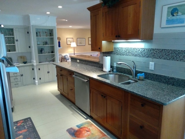 kitchen featuring recessed lighting, a sink, decorative backsplash, dishwasher, and brown cabinetry