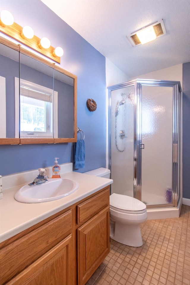 full bath featuring toilet, vanity, visible vents, and a shower stall