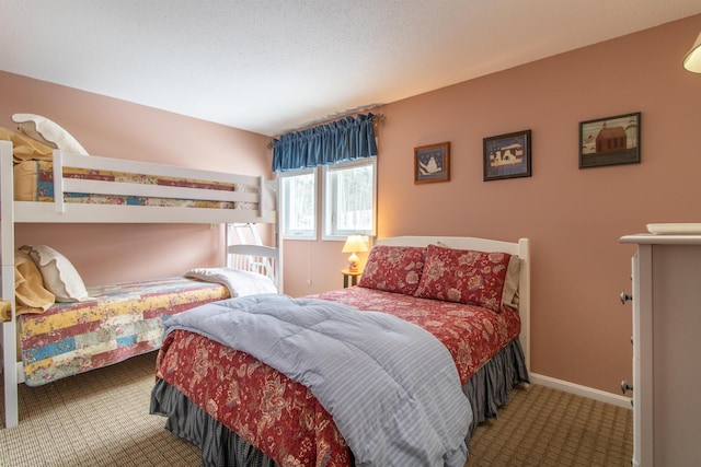 bedroom featuring carpet and baseboards