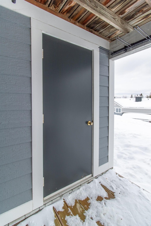 view of snow covered property entrance