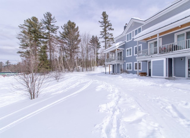 yard layered in snow featuring a garage