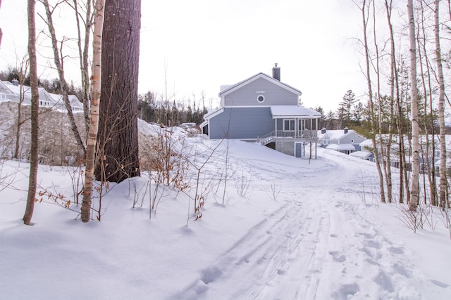 exterior space with a garage and a chimney