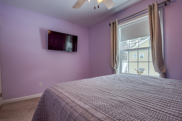 carpeted bedroom featuring ceiling fan and baseboards