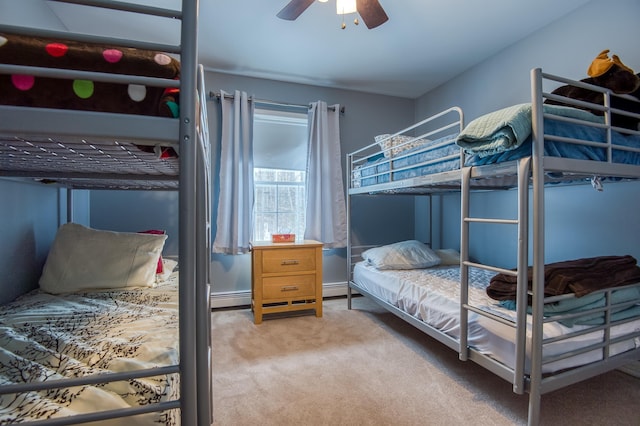 bedroom with a ceiling fan, light colored carpet, and baseboard heating